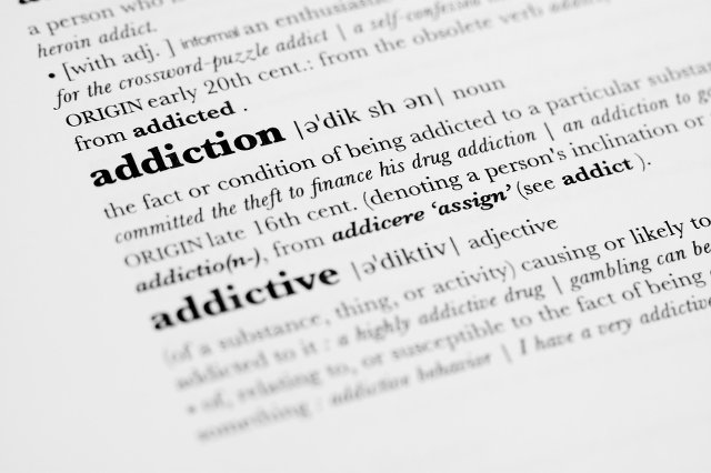 Photo of a dictionary highlighting the word addiction